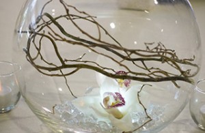 Fish bowl with twigs and flower