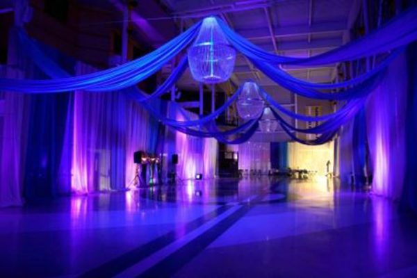 Ceiling Treatment with large chandeliers, drape, and uplighting
