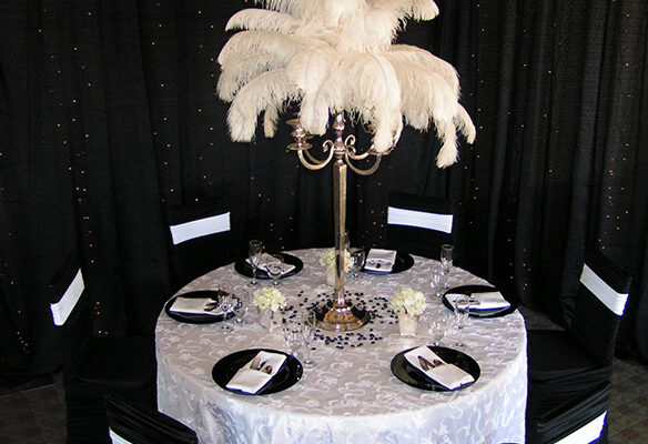 Feather and Silver Candelabra Centerpiece placed on White Tablecloth