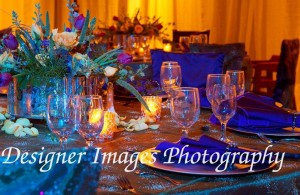 An elegant tablescape with floral arrangement and silver charger plates.