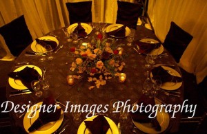 Floral arrangement and silver charger plates decorate a table for events
