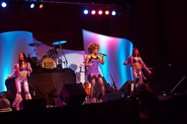 Tina Turner impersonator singing at corporate event