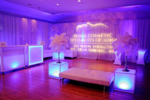 White Party with white couches, lit side tables, and feathered accent pieces